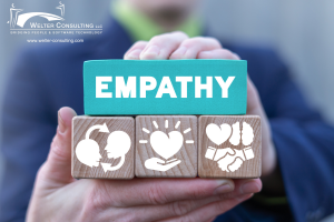 the word empathy and various other blocks being held by a person's hands